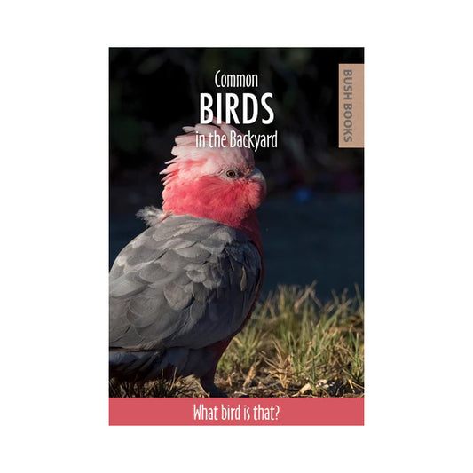 Front cover of a book titled 'Common Birds in the Backyard' by Bush Books, featuring a close-up photo of a pink and gray cockatoo standing on grass.
