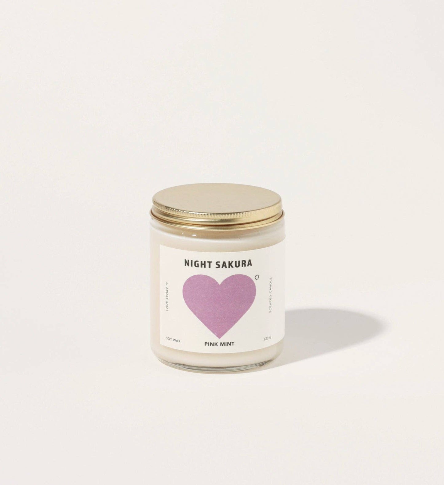 Candle with a heart-shaped label on a white background