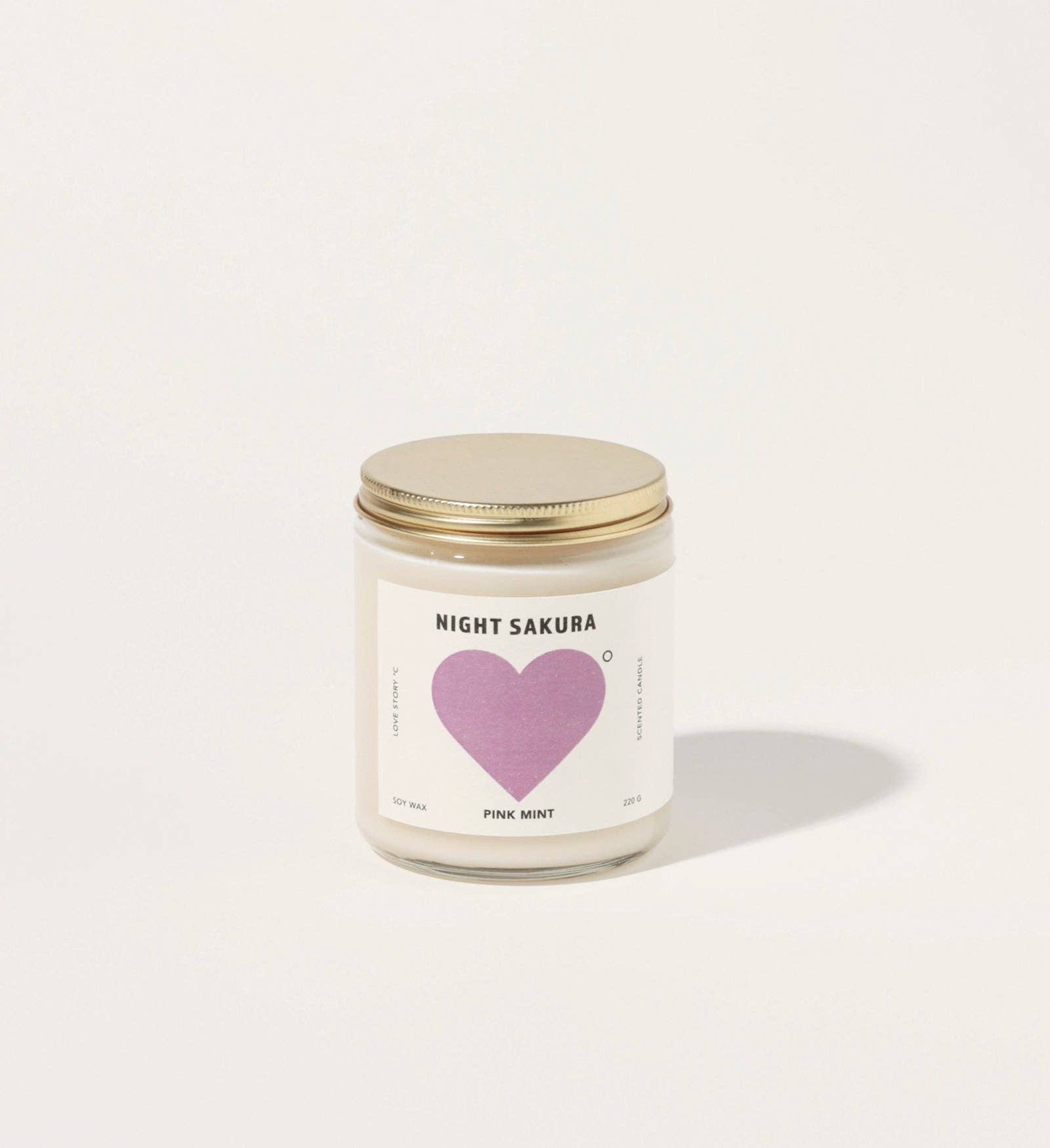 Candle with a heart-shaped label on a white background
