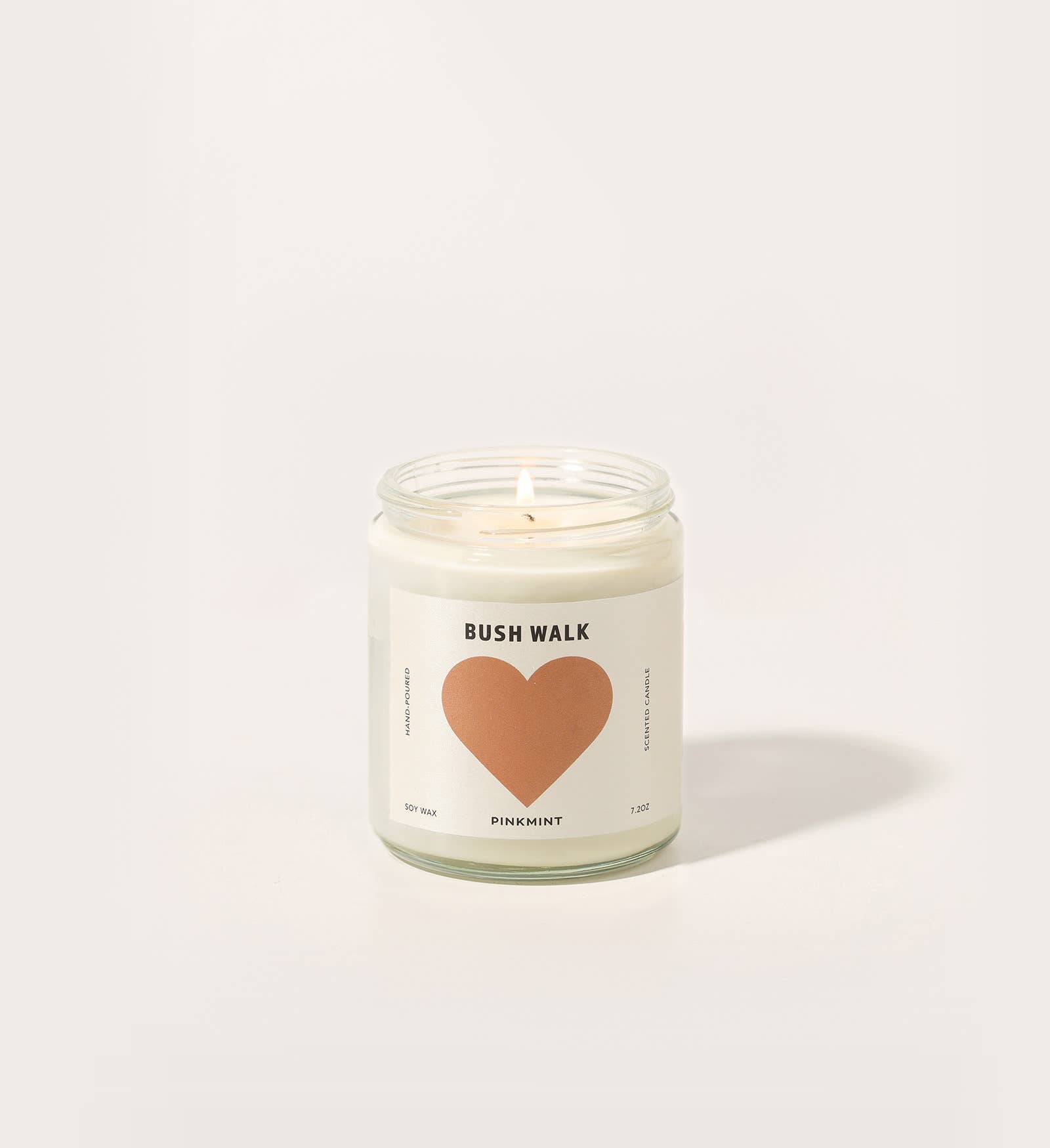 Candle with a heart-shaped label on a white background