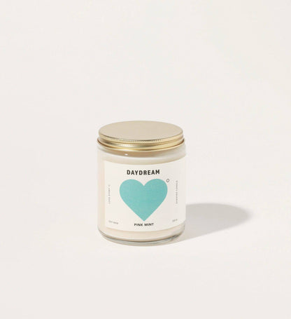 Candle jar with a heart-shaped label on a white background