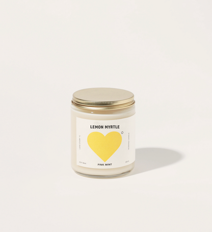 Candle with a yellow heart label on a white background
