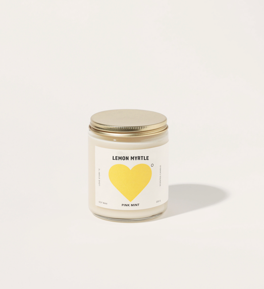 Candle with a yellow heart label on a white background