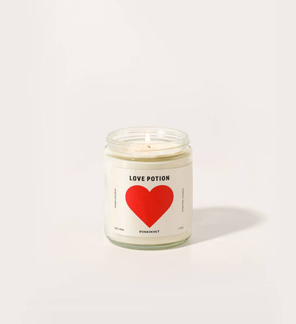 Candle jar with a red heart label on a white background